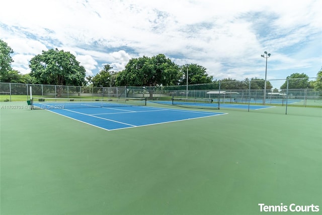 view of tennis court featuring basketball hoop