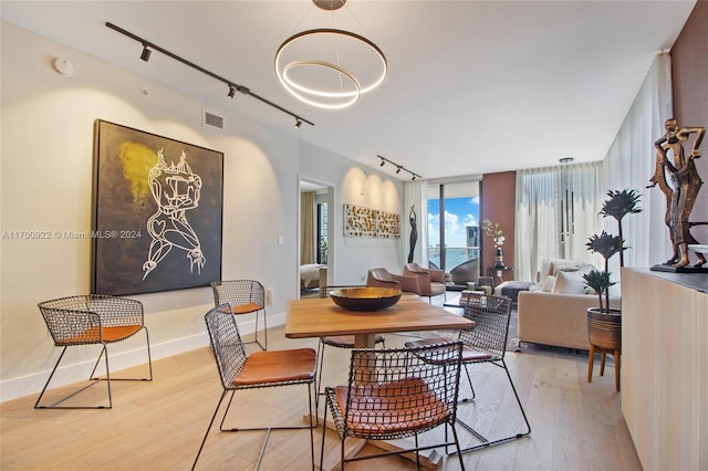 dining area featuring light hardwood / wood-style floors and rail lighting