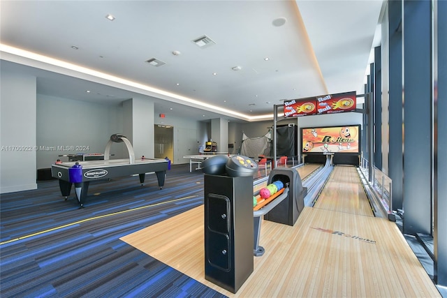 recreation room featuring light colored carpet and a bowling alley