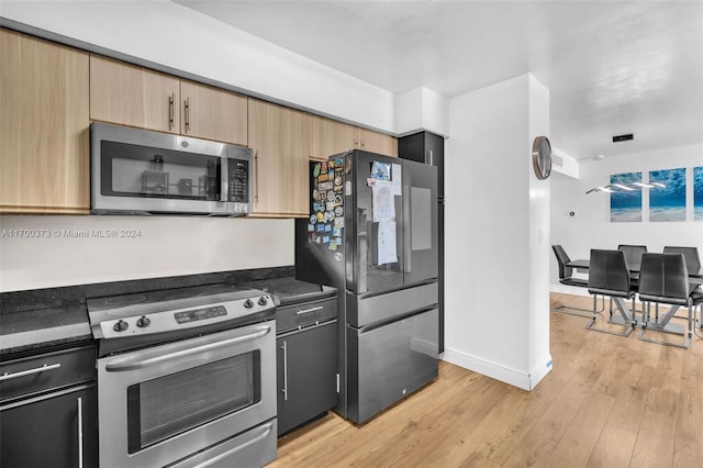 kitchen featuring appliances with stainless steel finishes, light hardwood / wood-style floors, and light brown cabinetry