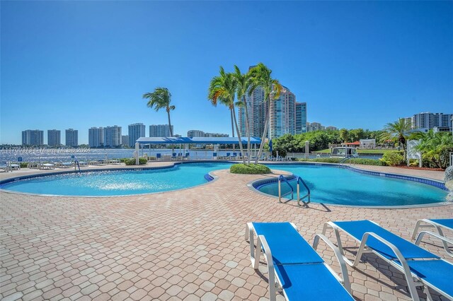 3530 Mystic Pointe Dr Unit 2907, Aventura, FL 33180 - community pool featuring a patio area and a view of skyline