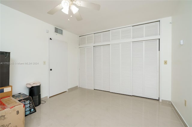 unfurnished bedroom featuring a closet and ceiling fan