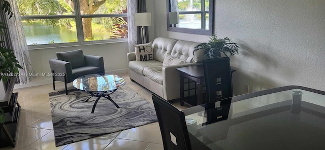 tiled living room featuring a water view