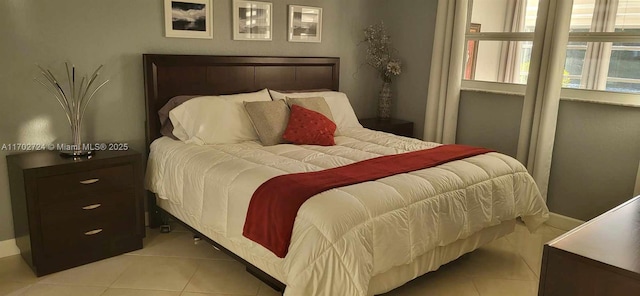 bedroom with light tile patterned floors