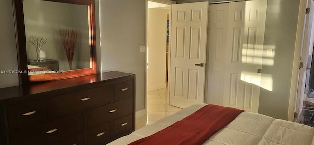 bedroom featuring light tile patterned floors and a closet