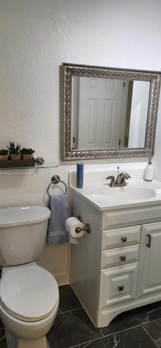 bathroom with vanity and toilet