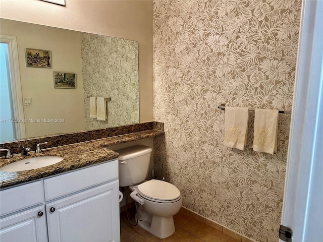 bathroom with tile patterned flooring, vanity, and toilet