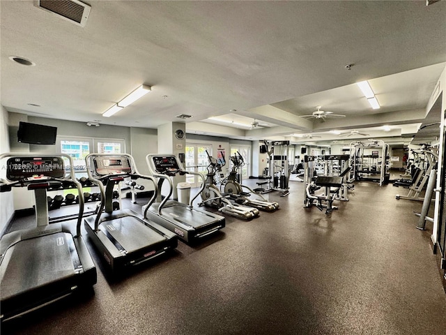 workout area with ceiling fan, a textured ceiling, and a wealth of natural light