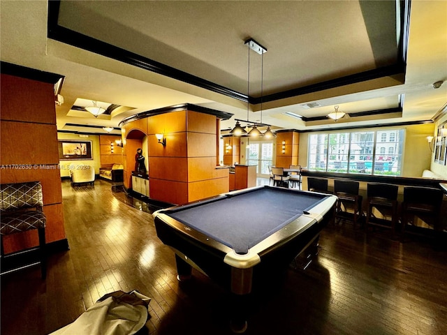 playroom featuring dark hardwood / wood-style floors, a raised ceiling, ornamental molding, and billiards