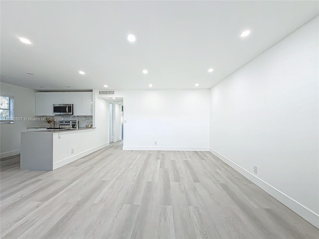 unfurnished living room with light hardwood / wood-style floors