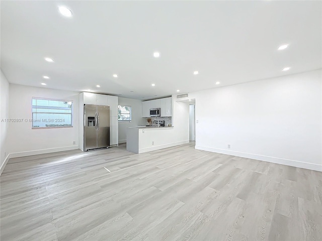 unfurnished living room featuring light hardwood / wood-style flooring