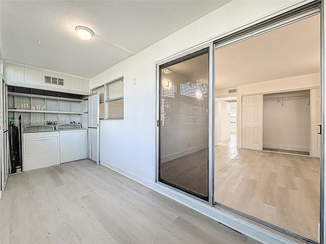 unfurnished sunroom with washing machine and dryer