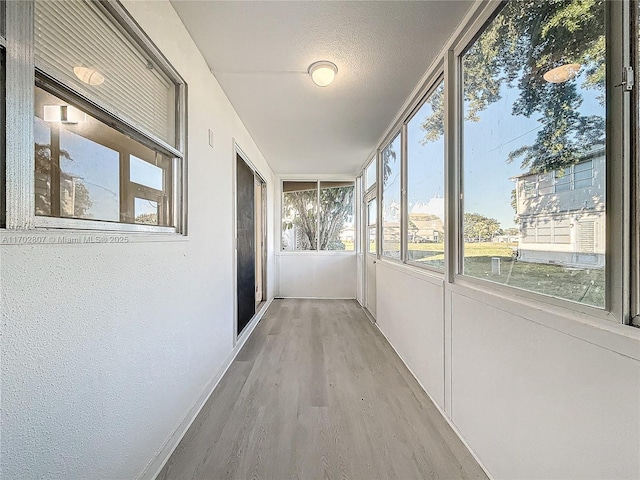unfurnished sunroom with wood finished floors