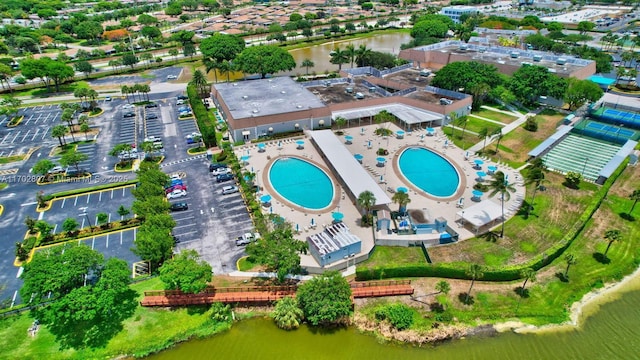 aerial overview of property's location featuring a pool area and a large body of water