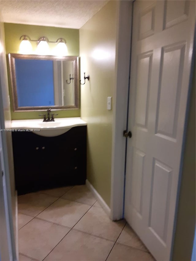 bathroom featuring tile patterned flooring and vanity