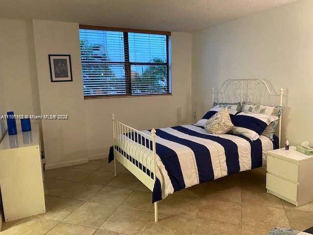 bedroom featuring light tile patterned floors