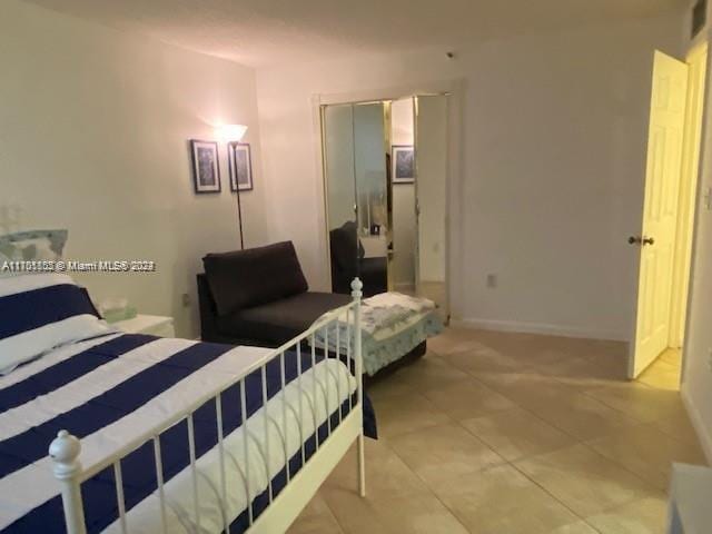 bedroom featuring light tile patterned floors