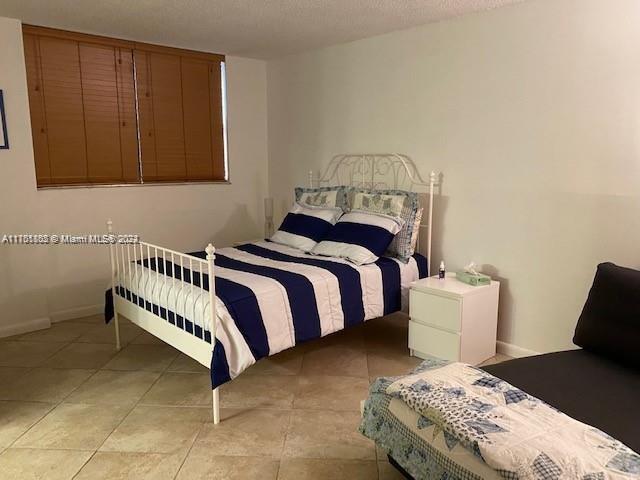 bedroom with light tile patterned floors