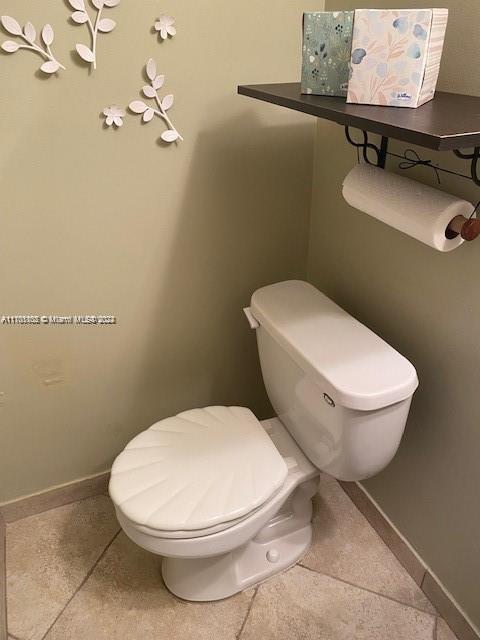 bathroom with tile patterned floors and toilet