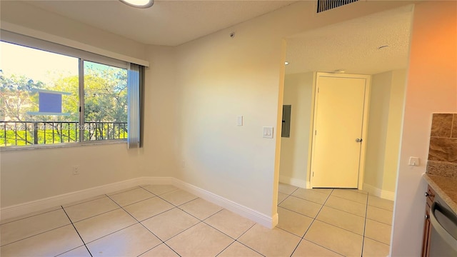 tiled empty room with electric panel