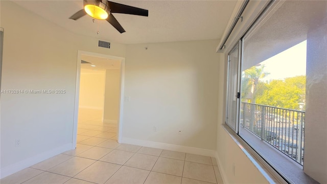 unfurnished room featuring light tile patterned floors and ceiling fan