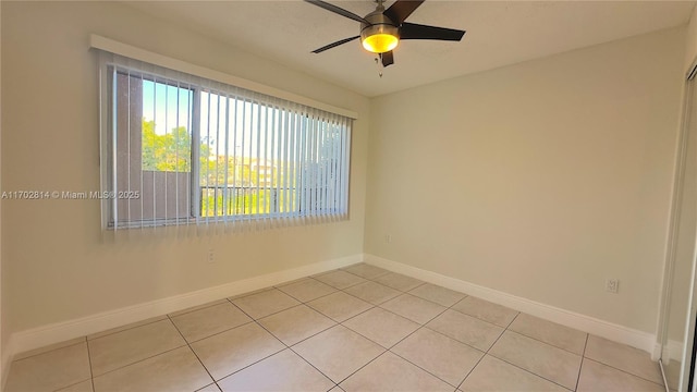 spare room with light tile patterned floors and ceiling fan