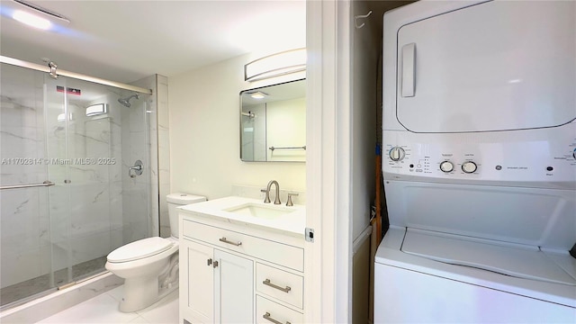 bathroom featuring tile patterned flooring, vanity, stacked washer and clothes dryer, toilet, and a shower with door