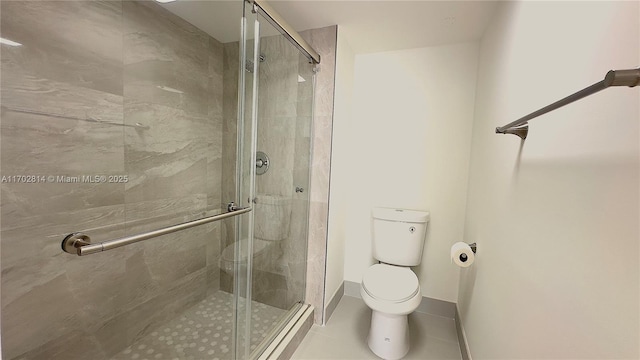 bathroom with toilet, a shower with shower door, and tile patterned flooring