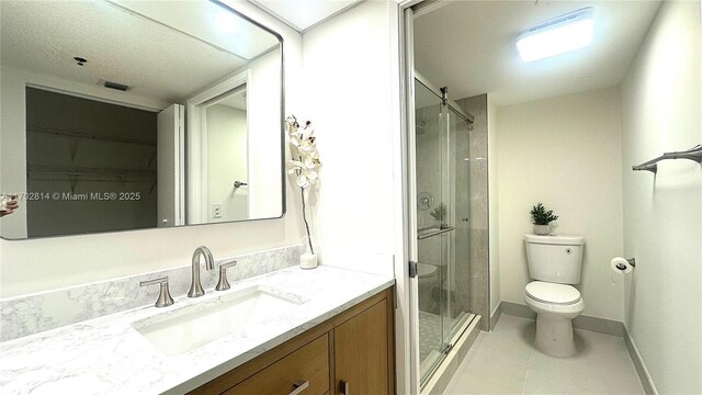 bathroom featuring vanity, toilet, and walk in shower