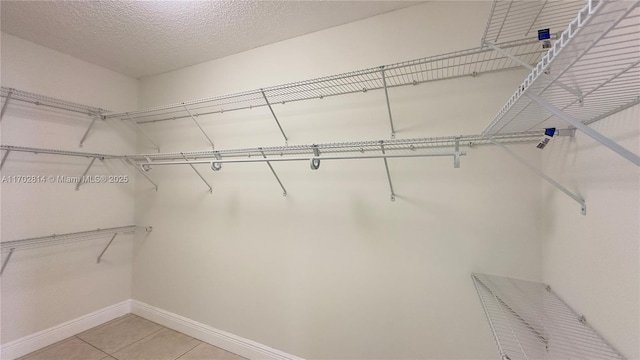 spacious closet with light tile patterned flooring