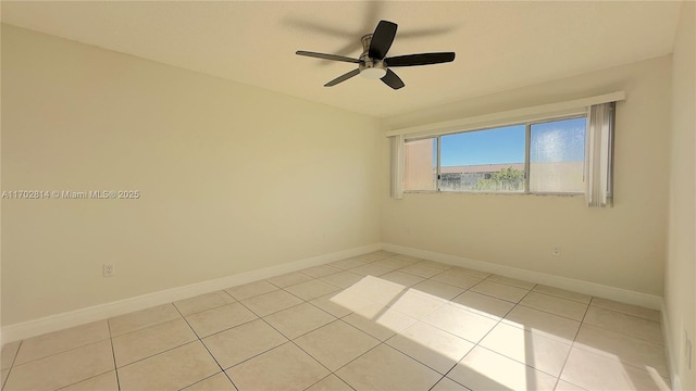 unfurnished room with ceiling fan and light tile patterned floors