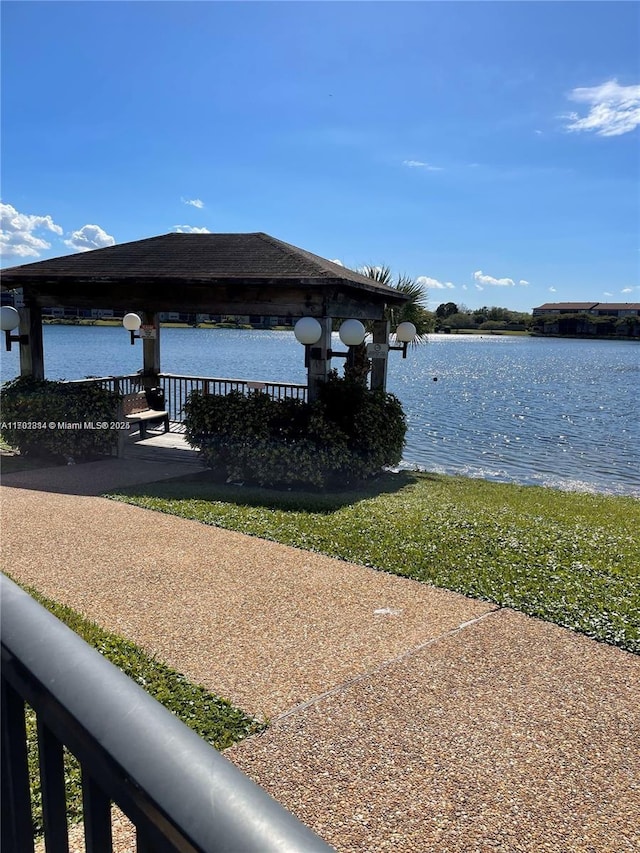 view of dock featuring a gazebo and a water view