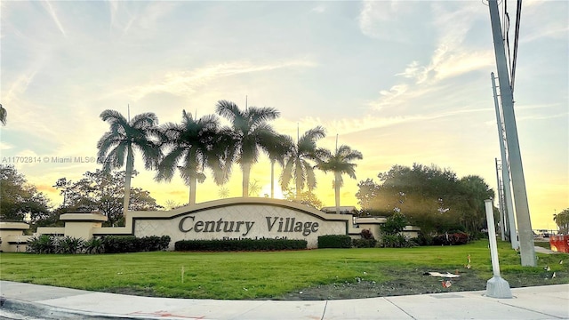 community sign featuring a lawn