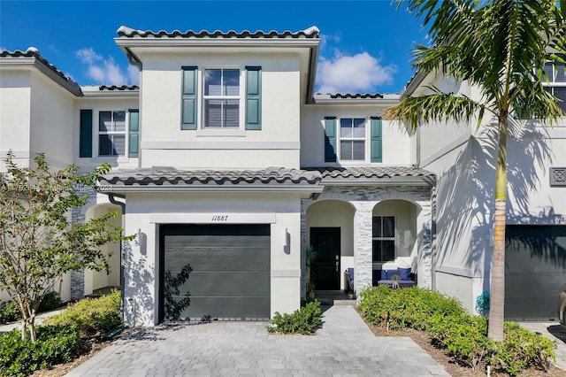 mediterranean / spanish-style house with a garage