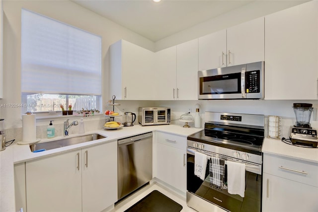 kitchen featuring white cabinets, sink, and stainless steel appliances