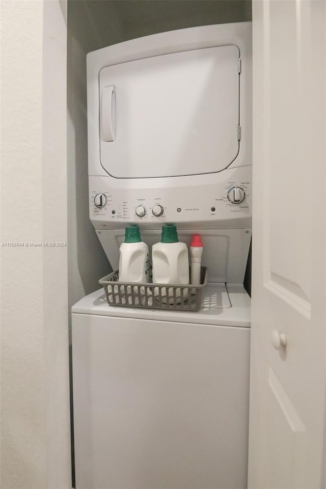 washroom featuring stacked washing maching and dryer