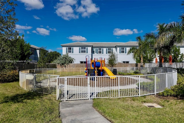 view of front of house with a playground and a front lawn