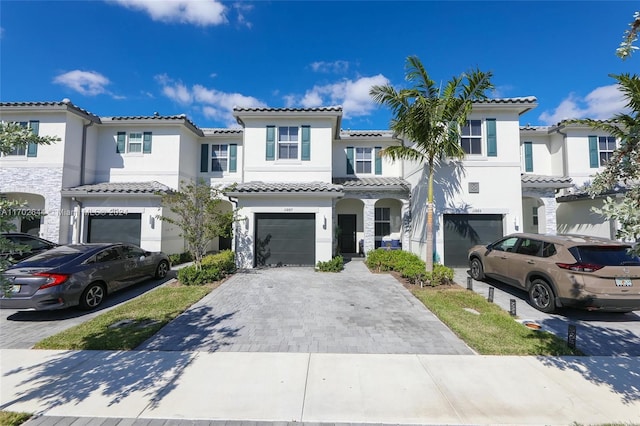 mediterranean / spanish-style home with a garage