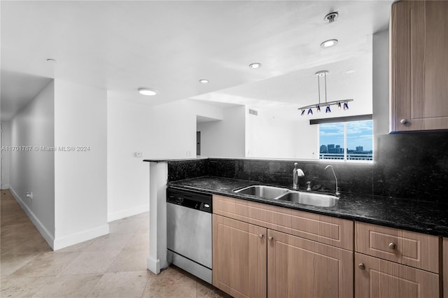 kitchen with sink, hanging light fixtures, stainless steel dishwasher, decorative backsplash, and dark stone countertops