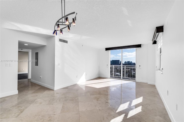 3000 Coral Way Unit 1502, Miami, FL 33145 - unfurnished room with a textured ceiling and baseboards