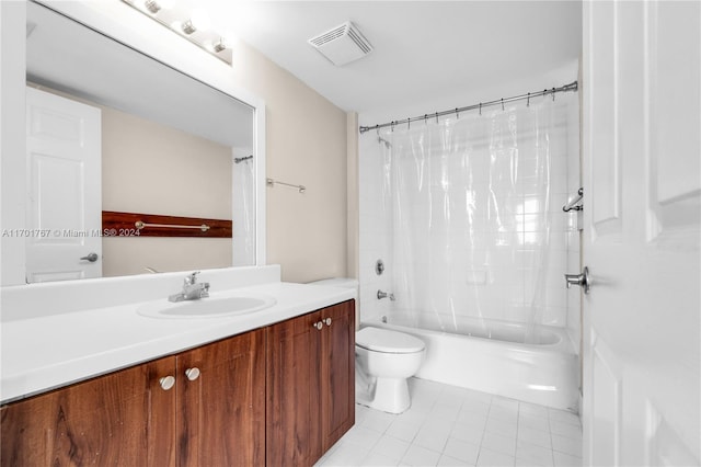 full bathroom with tile patterned floors, vanity, shower / tub combo, and toilet