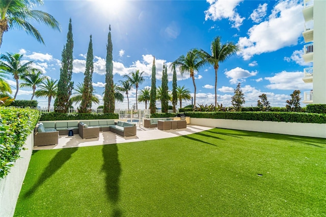 view of home's community featuring a lawn, a patio area, and an outdoor hangout area