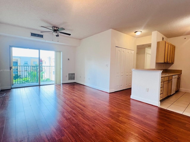 unfurnished living room with ceiling fan, light hardwood / wood-style floors, and a textured ceiling