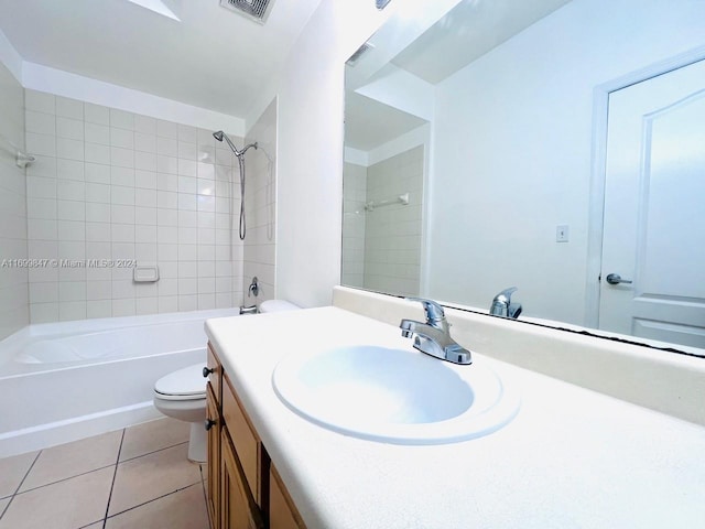 full bathroom featuring toilet, vanity, tile patterned floors, and tiled shower / bath