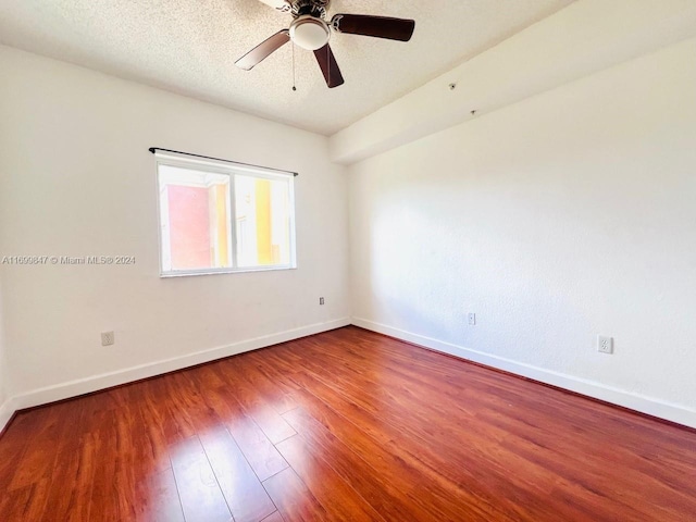 empty room featuring hardwood / wood-style floors, ceiling fan, and a textured ceiling