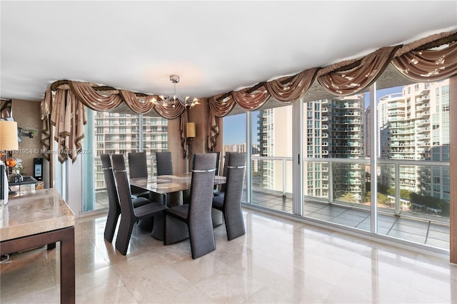 tiled dining area featuring a chandelier and a wall of windows