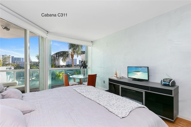 16500 Collins Ave Unit 1451, Sunny Isles Beach, FL 33160 - bedroom with expansive windows, baseboards, wood finished floors, and a city view