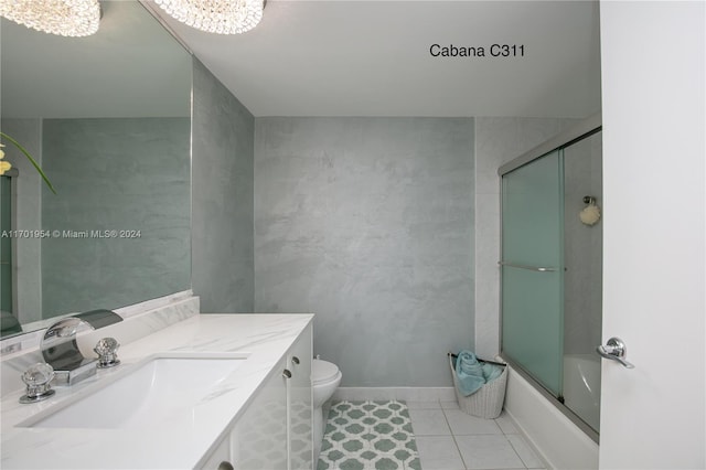 full bathroom with vanity, tile patterned flooring, toilet, enclosed tub / shower combo, and a chandelier