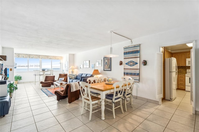 tiled dining area with a water view