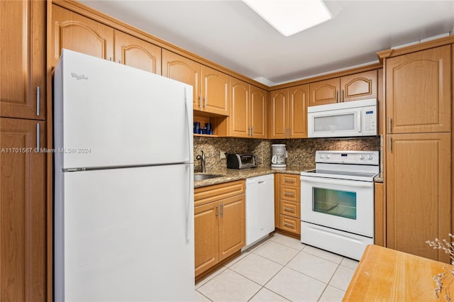 kitchen featuring sink, light stone counters, white appliances, decorative backsplash, and light tile patterned floors